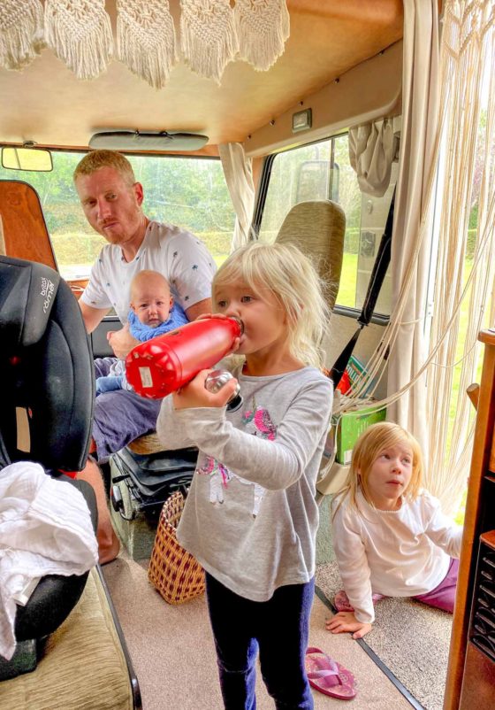 Family sat inside a classic Hymer motorhome