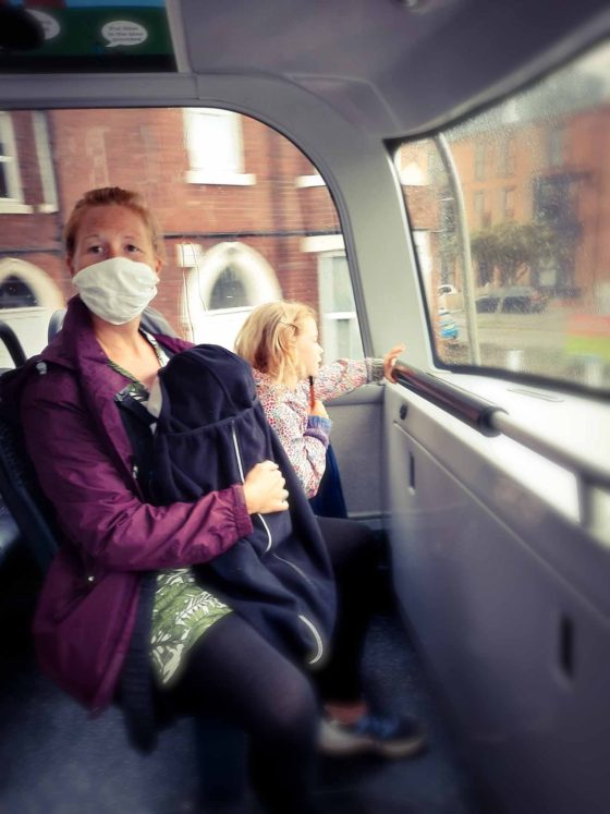 Mother and daughter sitting upstairs on a double-decker bus
