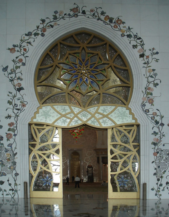 Looking through the main entrance door into the prayer hall at the Abu Dhabi grand mosque, decorated with geometric patterns