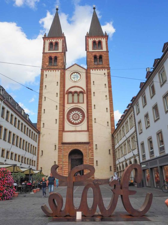 Tall church with 'love' sculpture in front