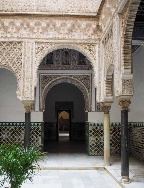 Intricate geometric stone carvings inside the Seville Alcazar