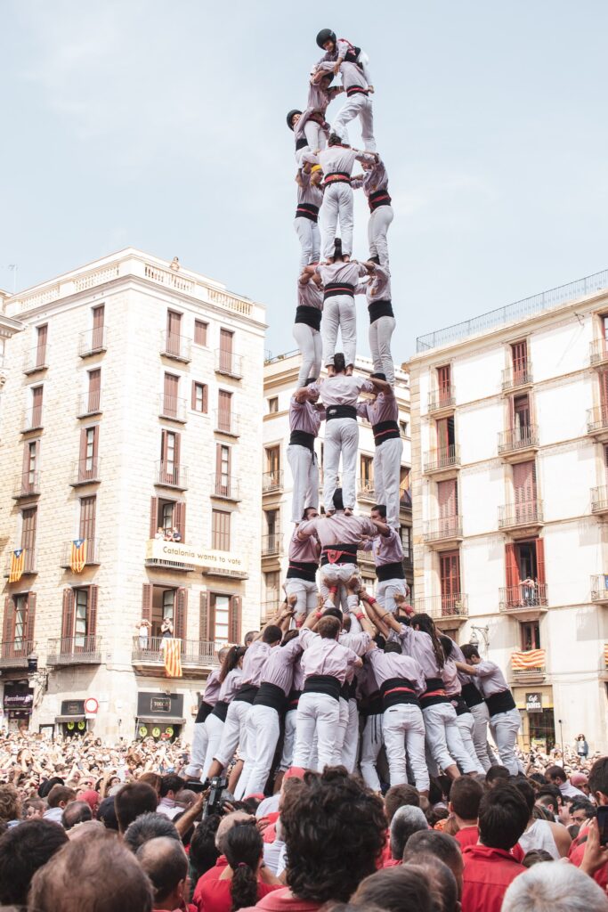 Human tower of people standing on each other's shoulders reaching over 10m high