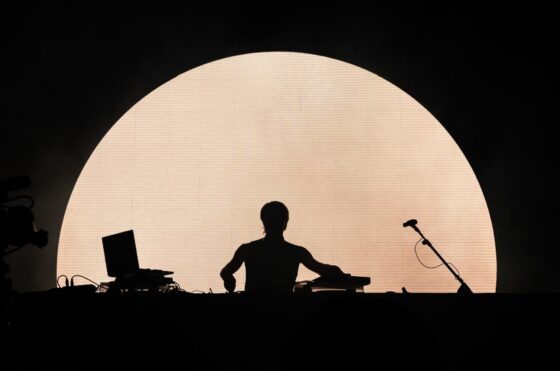 Silhouette of a DJ playing on stage