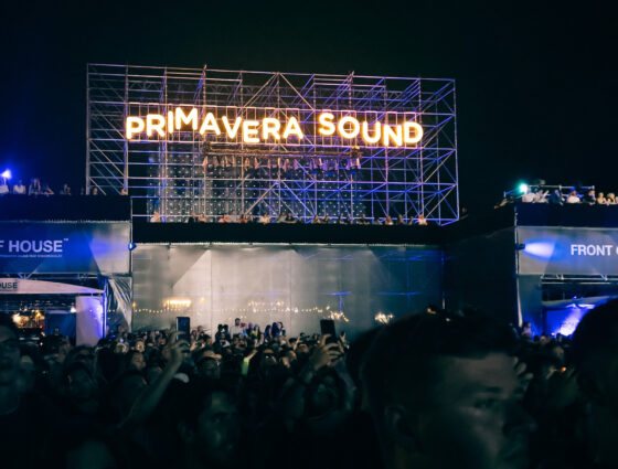 Crowds in front of an outdoor stage at night