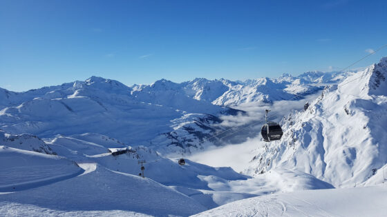 Snowy mountain scene with a gondola ski lift