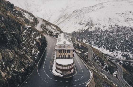 Hotel on a winding road through snowy mountains