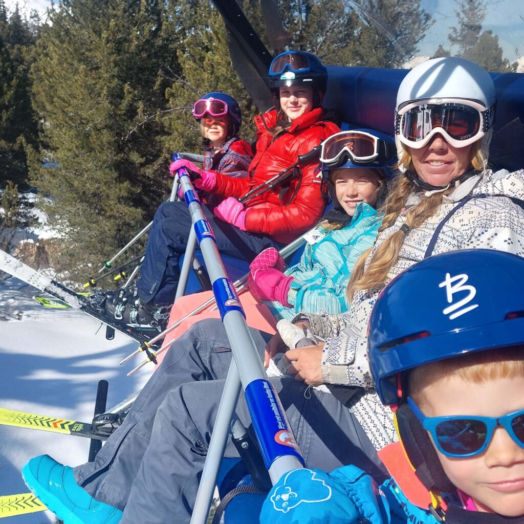 Family with small children sat on a ski chairlift