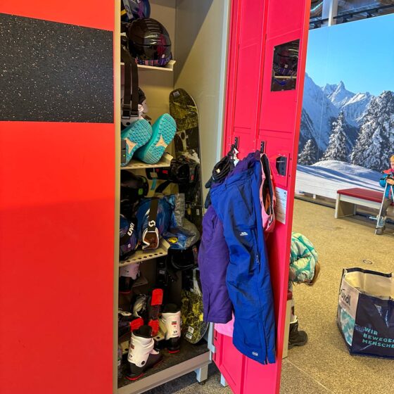 Inside a ski locker full of ski equipment