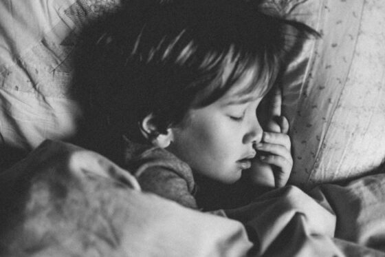 Black and white close up of a child sleeping