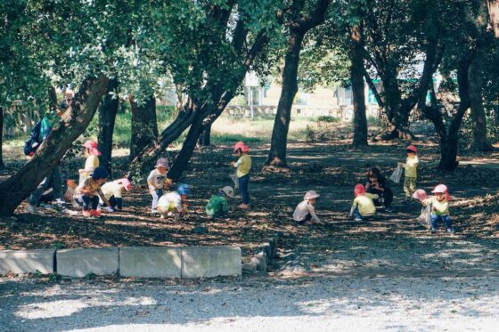 Group of small children learning in a woodland