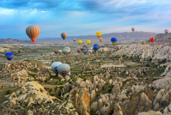 Hot air balloons flying over a rocky landscape