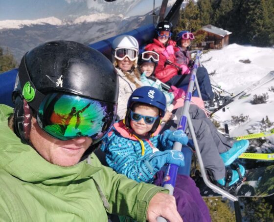 Family sitting on a ski chairlift