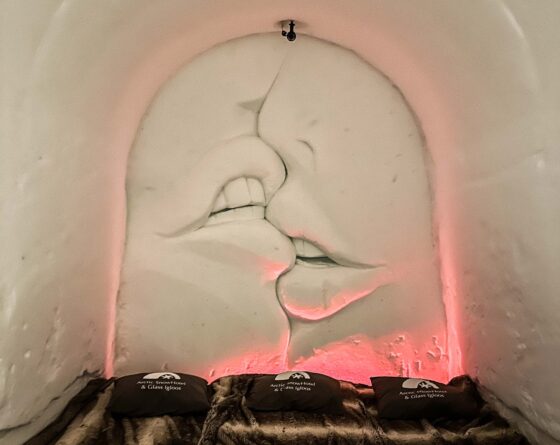Inside a snow room with a sculpture of large kissing lips carved into the wall